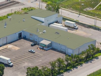 Arial view of a commercial building with a green TPO Mulehide rooftop