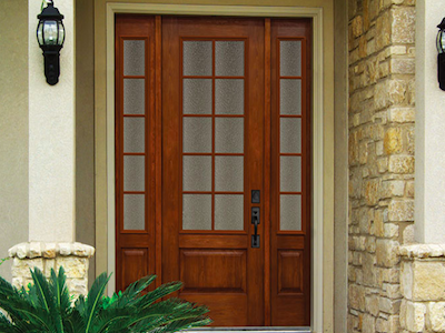Front view of a residential home with brown wooden Norandex front door