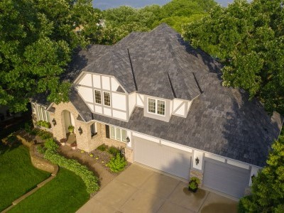 Arial view of a generic mid-class home with black Brava shingles on its roof
