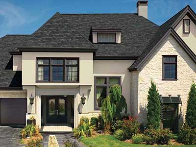 Front view of a generic mid-class home with black GAF shingles on its roof