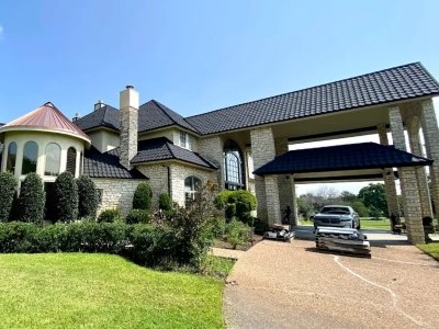 Front view of a generic mid-class home with black Roser shingles on its roof