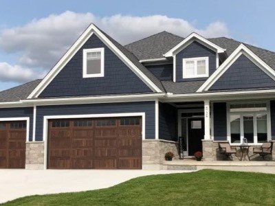 Front view of home with blue vinyl james hardie siding