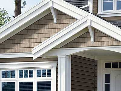 Front view of residential home with white LP vinyl siding